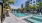 Sparkling swimming pool in West Palm Beach surrounded by poolside cabanas and lounge chairs.